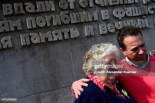 Contemporary witness takes a picture with a stranger by a memorial plaque during a ceremony to commemorate the 70th anniversary of the liberation of...