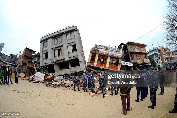 Local people and soldiers inspect debris of destroyed buildings after a powerful earthquake hits Katmandu, Nepal on April 26, 2015. The death toll in...