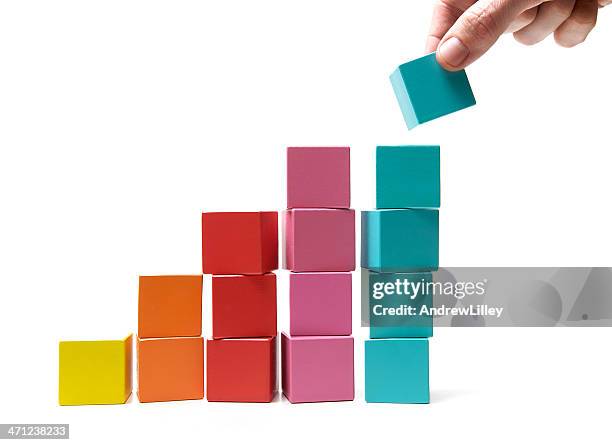 final touch to achievement - multi coloured hands stock pictures, royalty-free photos & images