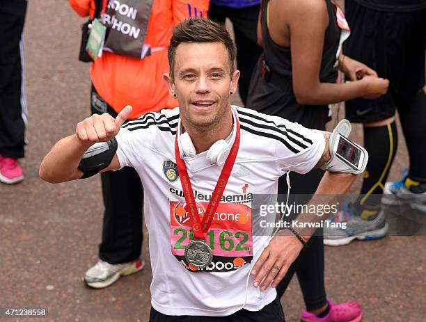 Lee Hendrie poses with his medal after completing the London Marathon on April 26, 2015 in London, England.