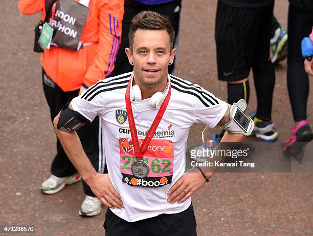 Lee Hendrie poses with his medal after completing the London Marathon on April 26, 2015 in London, England.
