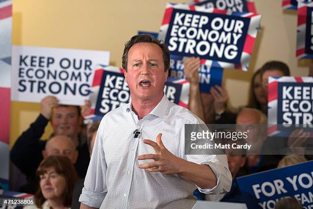 Prime Minister David Cameron speaks to party supporters gathered inside the village hall in Norton Sub Hamdon in the Yeovil constituency on April 26,...