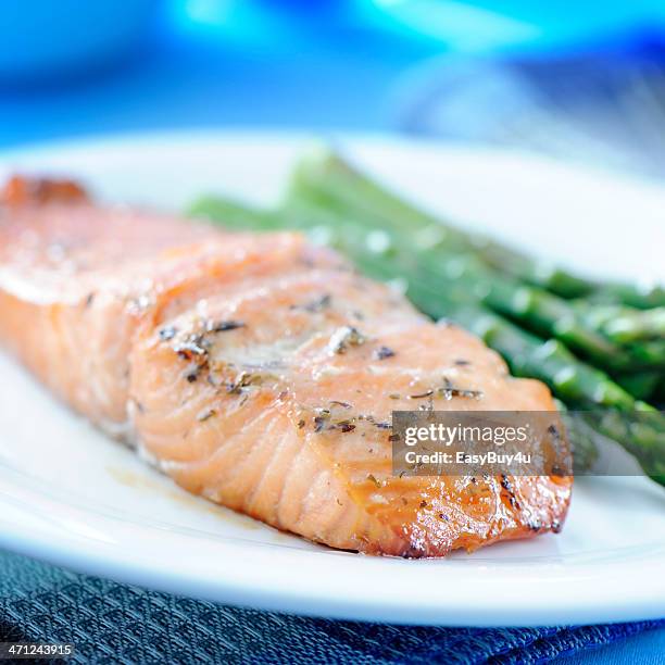 baked salmon and asparagus on a white plate - baked salmon stock pictures, royalty-free photos & images