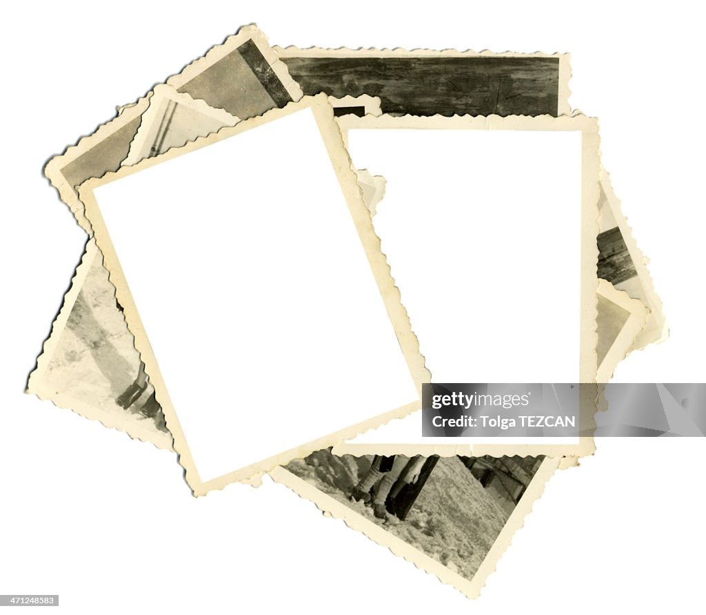 Stack of old photos with two blank on top