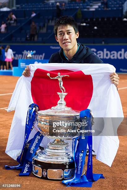 Kei Nishikori of Japan poses with the trophy of the Barcelona Open Banc Sabadell after defeating Pablo Andujar of Spain on the final match during day...