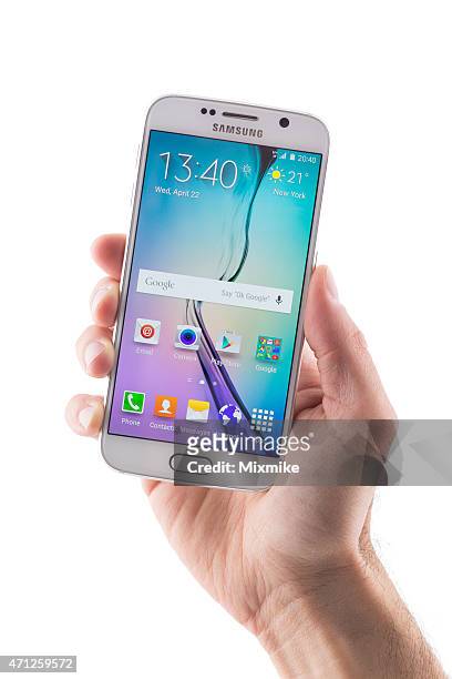 hand holding samsung galaxy s6 with clipping path on display - android phone stock pictures, royalty-free photos & images