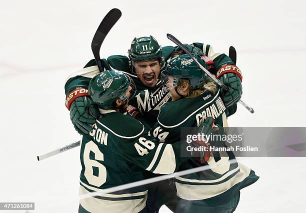 Zach Parise of the Minnesota Wild celebrates scoring a short-handed goal against the St. Louis Blues with teammate Jared Spurgeon and Mikael Granlund...