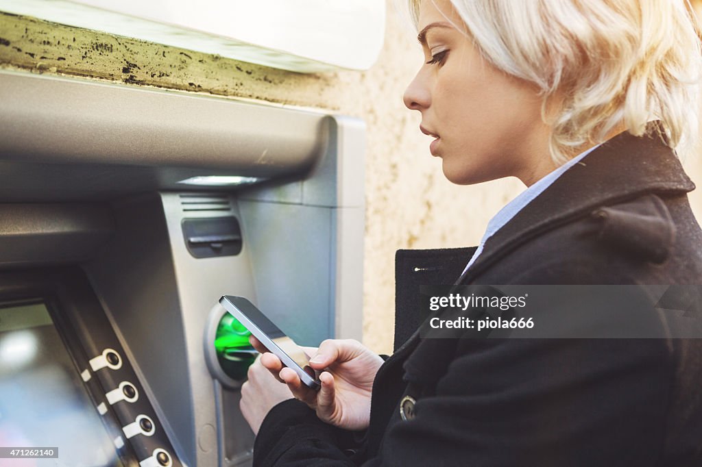 Business woman credit card withdrawal at bank