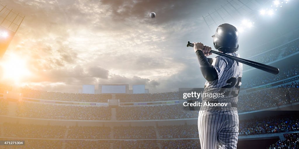 Baseball player hitting a ball in stadium