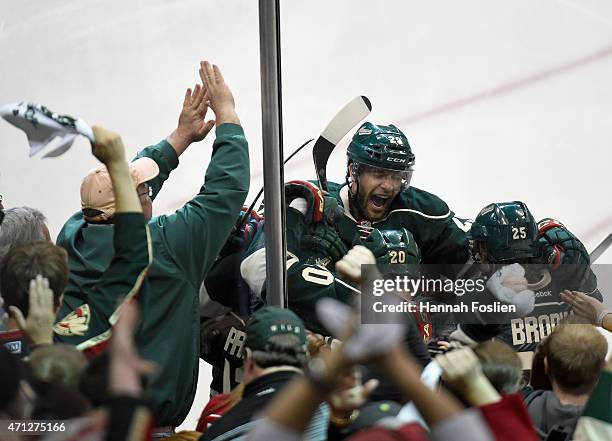 Jason Pominville of the Minnesota Wild celebrates a goal by teammate Zach Parise against the St. Louis Blues during the third period in Game Six of...