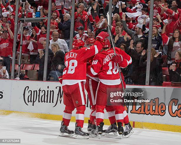 Riley Sheahan and Marek Zidlicky of the Detroit Red Wings congratulate teammate Joakim Andersson on scoring a goal in Game Four of the Eastern...