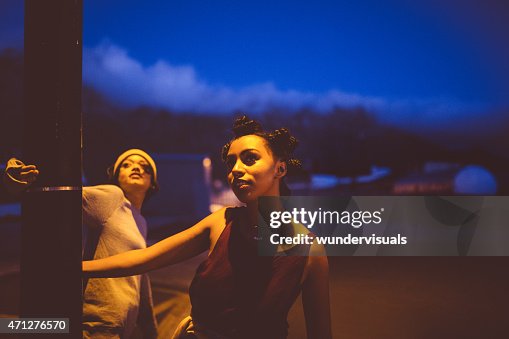 Teen grunge girls hanging out under a street light Teen grunge girls hanging out under a street light