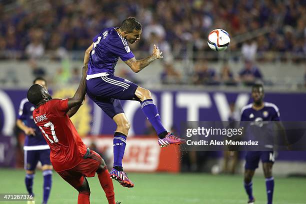 Seb Hines of the Orlando City SC heads the ball in front of Jozy Altidore of Toronto FC during an MLS soccer match between Toronto FC and the Orlando...