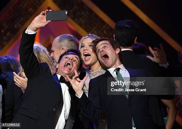 Actors Chad Duell, Kelli Goss, and Greg Rikaart take a selfie onstage during The 42nd Annual Daytime Emmy Awards at Warner Bros. Studios on April 26,...