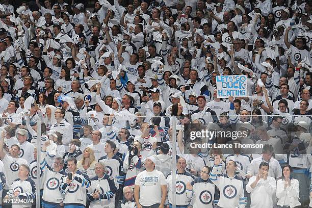 Winnipeg Jets fans stand and wave white towels as part of the "Whiteout' prior to puck drop between the Jets and the Anaheim Ducks for Game Three of...