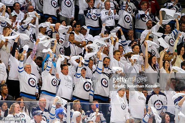 Winnipeg Jets fans stand and wave towels in support of the team during the overtime period against the Anaheim Ducks in Game Three of the Western...