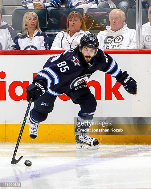 Mathieu Perreault of the Winnipeg Jets plays the puck up the ice during third-period action against the Anaheim Ducks in Game Three of the Western...