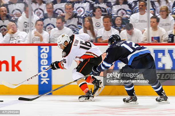 Emerson Etem of the Anaheim Ducks plays the puck away from Drew Stafford of the Winnipeg Jets during third-period action in Game Three of the Western...