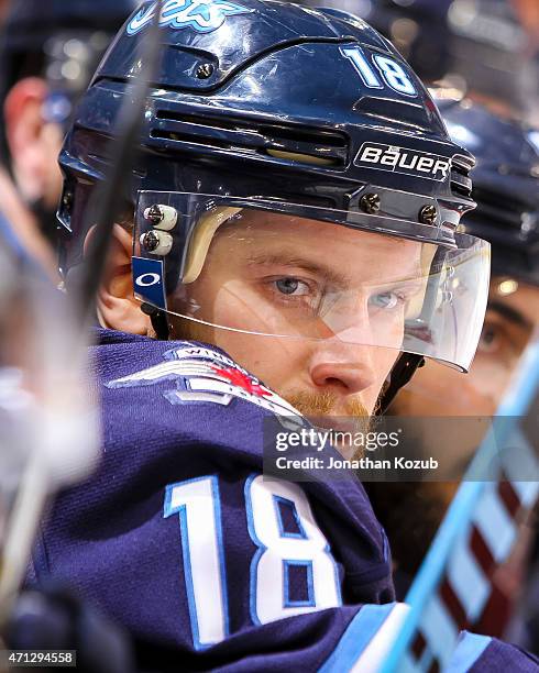 Bryan Little of the Winnipeg Jets looks on from the bench during third-period action against the Anaheim Ducks in Game Three of the Western...