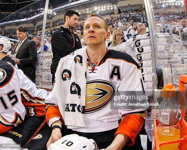 Corey Perry of the Anaheim Ducks looks on from the bench prior to the start of overtime between the Ducks and the Winnipeg Jets in Game Three of the...