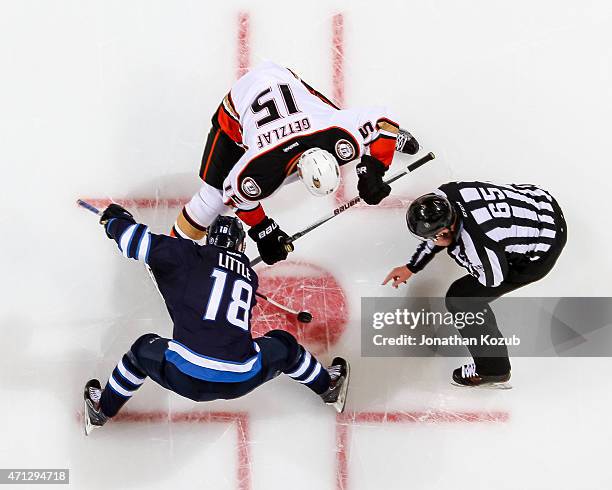 Bryan Little of the Winnipeg Jets wins a second period faceoff against Ryan Getzlaf of the Anaheim Ducks in Game Three of the Western Conference...