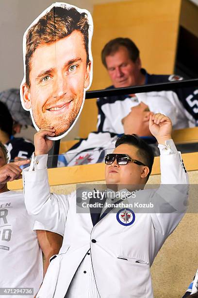 Fan holds up a large cutout of Blake Wheeler of the Winnipeg Jets during first-period action between the Jets and the Anaheim Ducks in Game Three of...