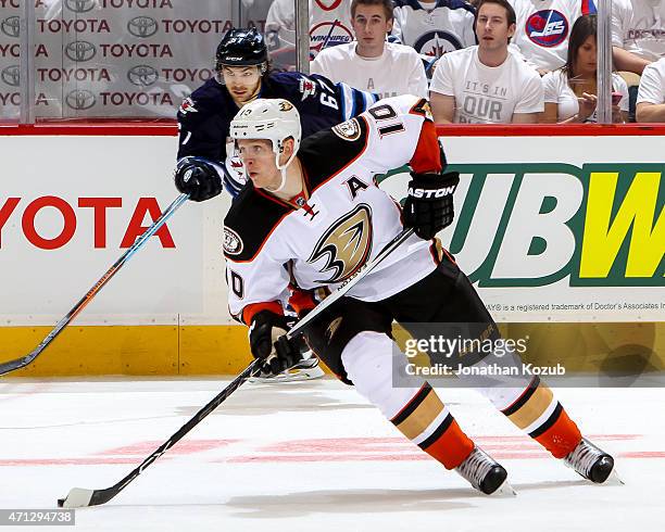 Corey Perry of the Anaheim Ducks plays the puck up the ice during overtime against the Winnipeg Jets in Game Three of the Western Conference...