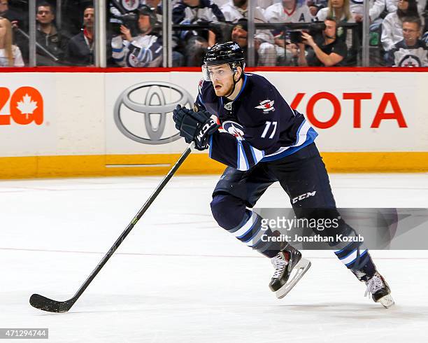 Adam Lowry of the Winnipeg Jets follows the play down the ice during overtime against the Anaheim Ducks in Game Three of the Western Conference...