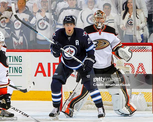 Blake Wheeler of the Winnipeg Jets and goaltender Frederik Andersen of the Anaheim Ducks keep an eye on the play at the point during overtime in Game...