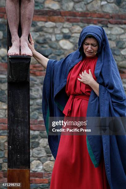 The Virgin Mary at the foot of his son Jesus crucified.