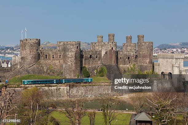 conwy castle and a passenger train north wales - wales stock pictures, royalty-free photos & images