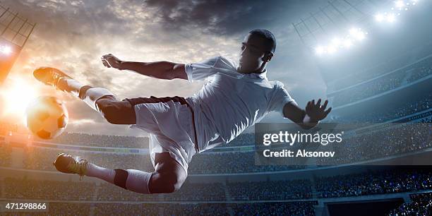 soccer player kicking ball in stadium - shooting football stock pictures, royalty-free photos & images