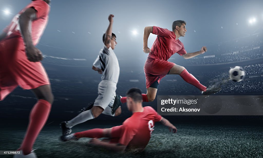 Soccer player kicking ball in stadium