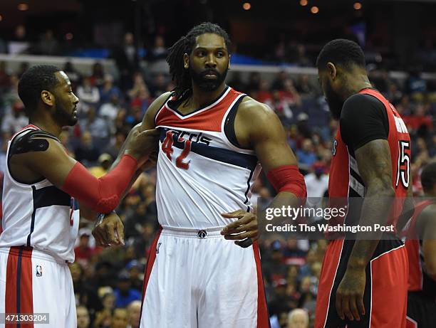 Washington Wizards guard John Wall holds back Washington Wizards forward Nene Hilario in the first quarter against the Toronto Raptors during game...