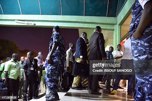 Members of the electoral committee, observers and representatives of the candidates arrive at the headquarters of the Independent National Electoral...