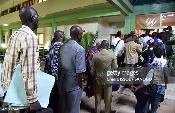 Members of the electoral committee, observers and representatives of the candidates arrive at the headquarters of the Independent National Electoral...