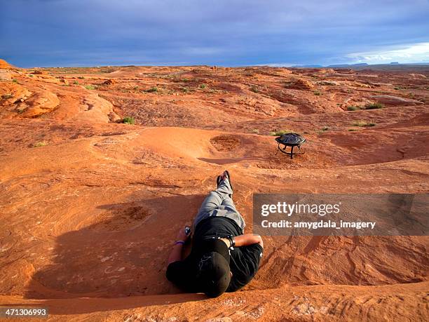 man laying down watching the sunset desert landscape - san rafael desert stock pictures, royalty-free photos & images