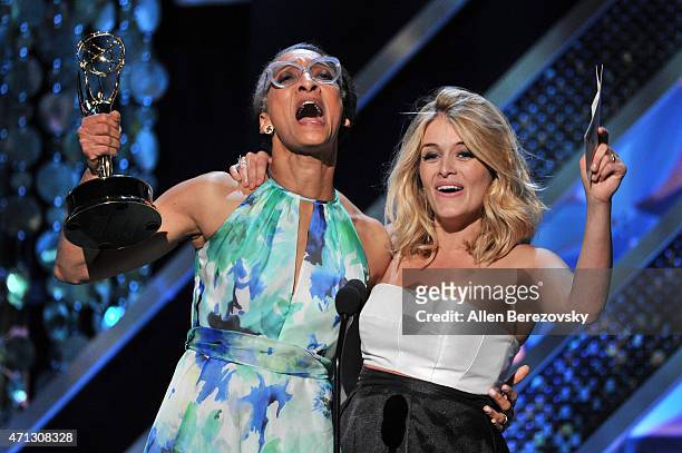 Personalities Carla Hall and Daphne Oz accept the Outstanding Informative Talk Show Host award onstage during the 42nd Annual Daytime Emmy Awards at...