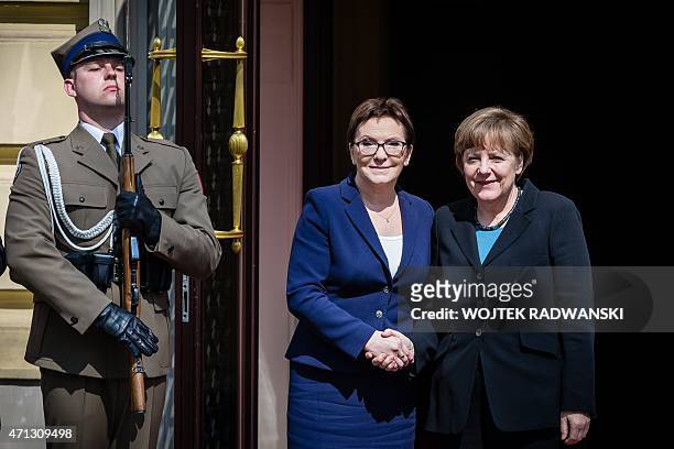 Polish Prime Minister Ewa Kopacz greets German Chancellor Angela Merkel during welcoming ceremony at the beginning of Polish-German Government...
