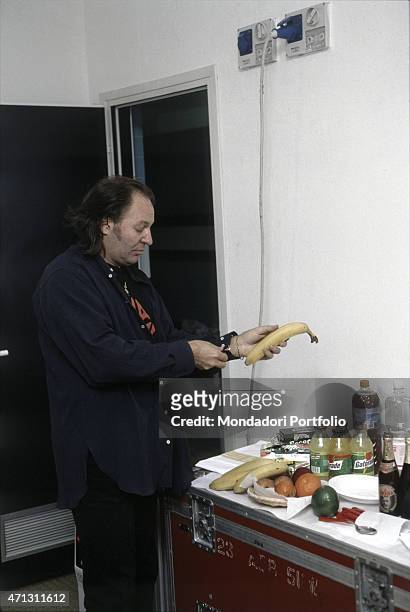 The Italian rock singer Vasco Rossi in his dressing-room during the rehearsals of Nessun pericolo... Per te tour; he is holding a banana while he is...