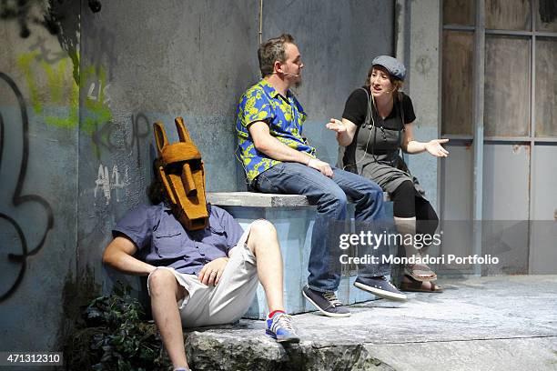Marco Silvestri, seated with his legs open and a mask on his face, plays the part of Bottom in the comedy A Midsummer Night's Dream by William...