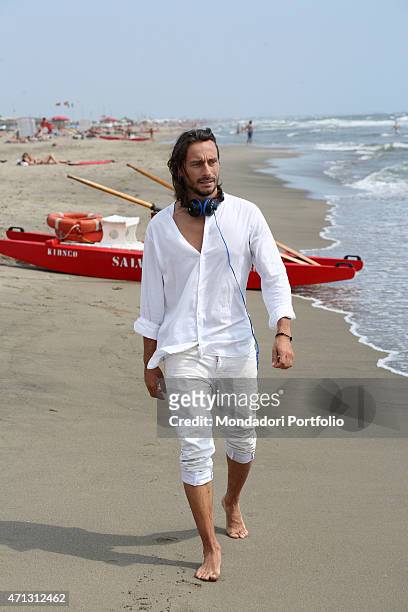 The French dj Bob Sinclar, pseudonym of Christophe Le Friant, walking on the seashore during a photo shoot on July 1st on the beach of Fregene, Rome .