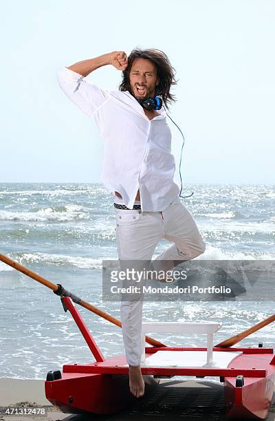 The French dj Bob Sinclar, pseudonym of Christophe Le Friant, jumps in front of a rowing boat during a photo shoot on July 1st on the beach of...