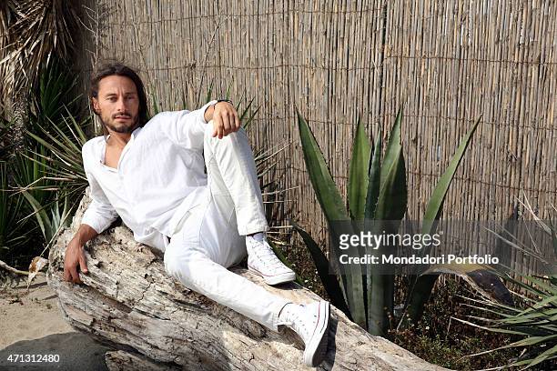 The French dj Bob Sinclar, pseudonym of Christophe Le Friant, leaning on a trunck during a photo shoot on July 1st on the beach of Fregene, Rome .