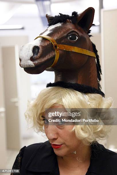 The Italian comic actress Maria Di Biase joking with a blond wig and a false horse head. Teatro Camploy, Verona , June 28th, 2011.