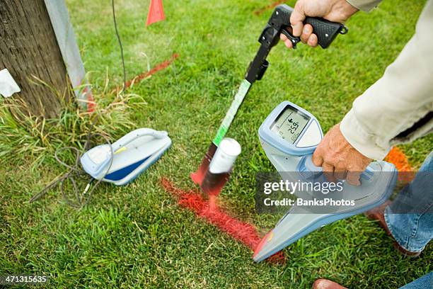 electric utility locator using radio frequency detector to mark line - utility locator stock pictures, royalty-free photos & images