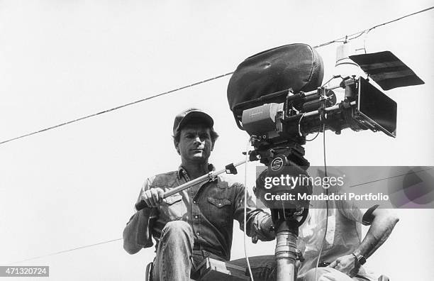 Italian actor and director Terence Hill using a camera on the set of the film The World of Don Camillo. 1983