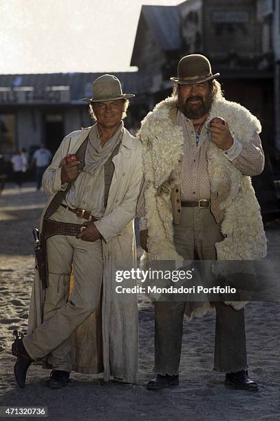 Italian actor and director Terence Hill and Italian actor Bud Spencer smiling with an apple in the hand in the film Troublemakers. Santa Fe, 1994