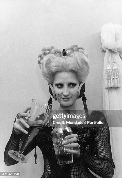 Italian-born Swiss singer and TV presenter Mina making a potion in the film For Love For Magic. 1966