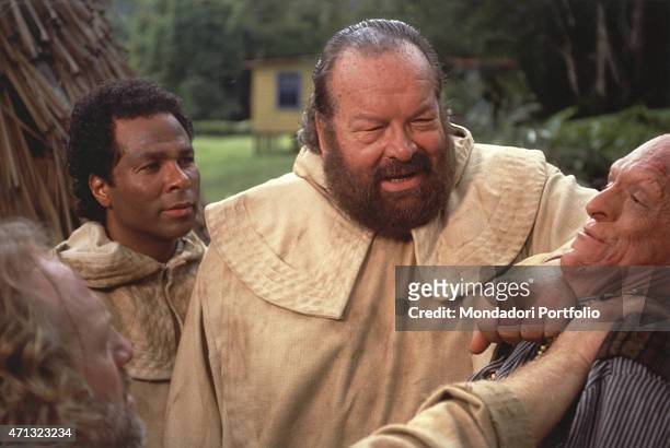 Italian actor Bud Spencer dressed as a missionary friar threatening a man in the TV series We Are Angels. American actor Philip Michael Thomas...